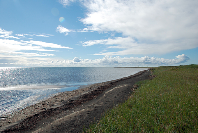 The shoreline of Cape Espenburg with clouds in the sky.